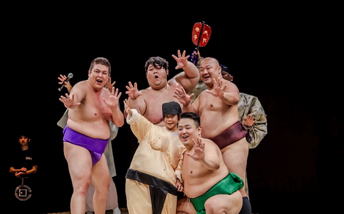 Sumo wrestlers posing at The Sumo Hall Hirakuza in Osaka.