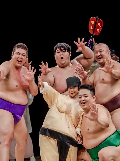Sumo wrestlers posing at The Sumo Hall Hirakuza in Osaka.