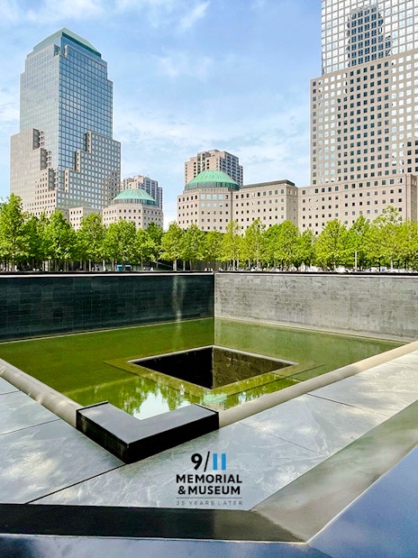 #Reflecting pool at 9/11 Memorial in New York City with surrounding skyscrapers.