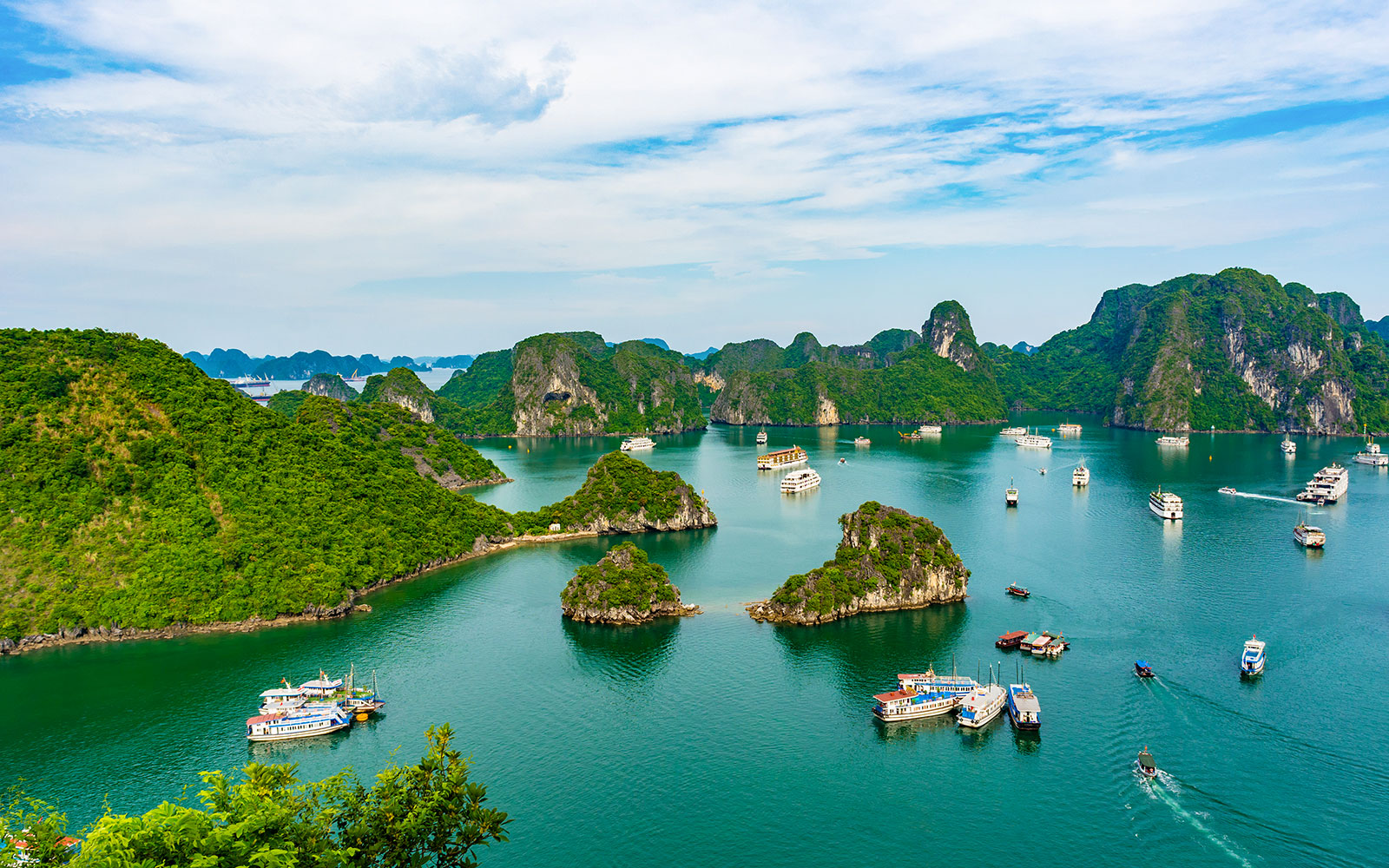 Aerial view of Ha Long Bay with boats and limestone islands in Vietnam.