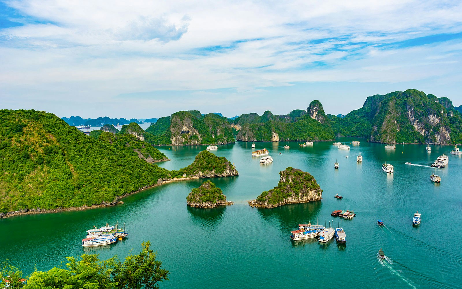 Aerial view of Ha Long Bay with boats and limestone islands in Vietnam.
