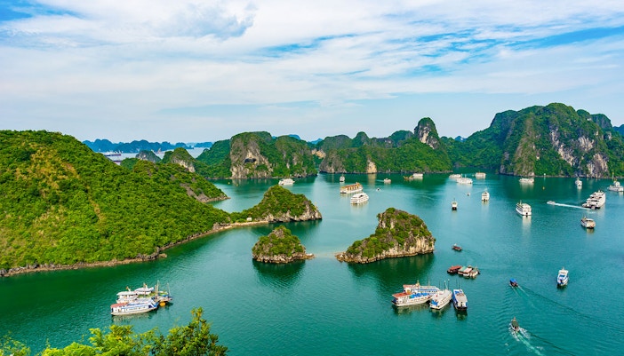 Aerial view of Ha Long Bay with boats and limestone islands in Vietnam.