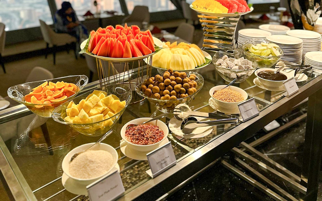 Buffet spread with fruits and condiments at ORBIT Revolving, KL Tower.