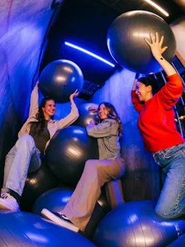 Visitors enjoying an interactive experience with exercise balls at Prison Island Perth.