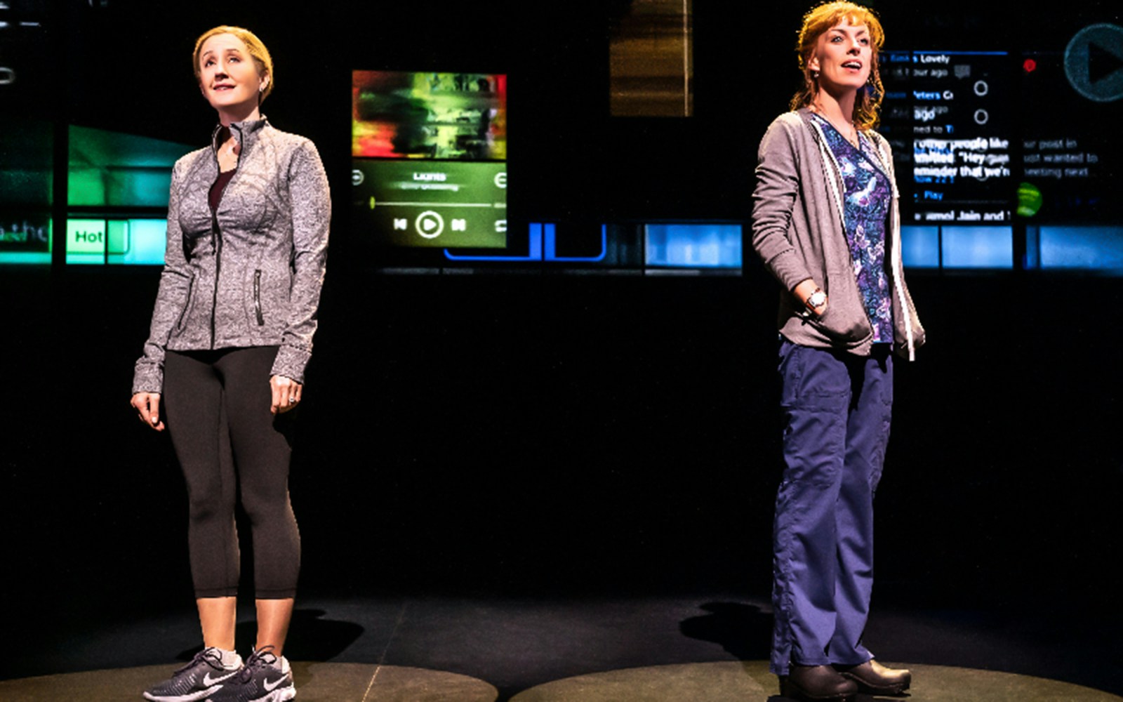Two actors performing a scene from the musical Dear Evan Hansen on stage.