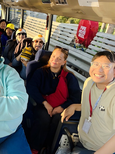 Tourists wearing penguin hats on a coach to Phillip Island.