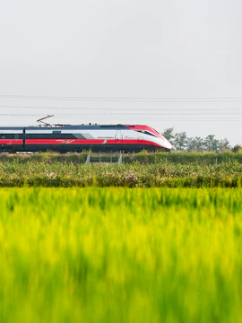 High-speed train traveling through Italian countryside, Italo Pass.