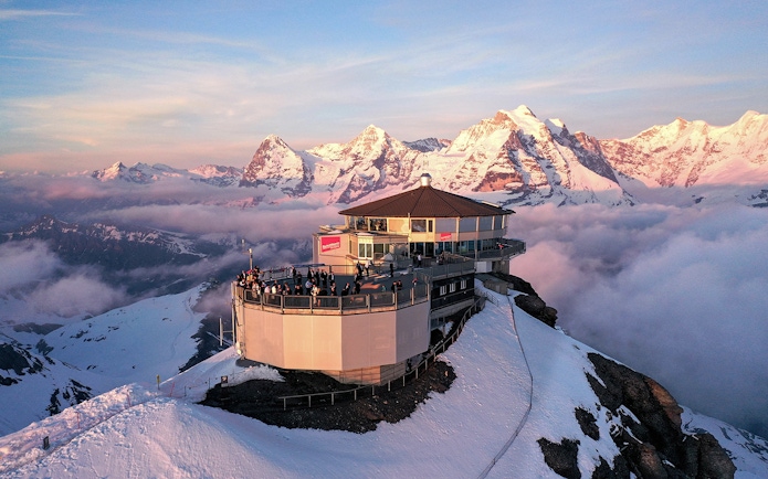 Aerial view of Piz Gloria Schilthorn with snow-capped Alps, Switzerland.