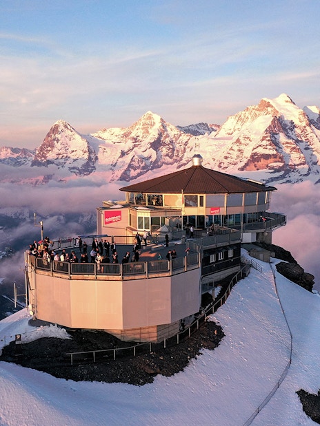 Aerial view of Piz Gloria Schilthorn with snow-capped Alps, Switzerland.