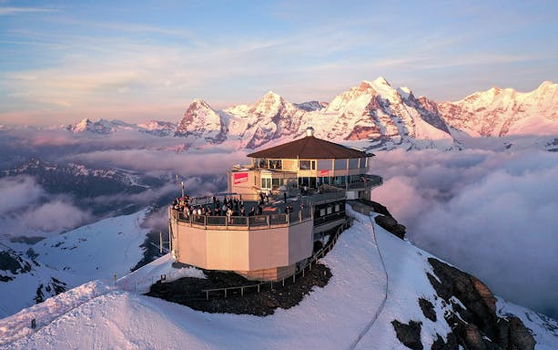 Aerial view of Piz Gloria Schilthorn with snow-capped Alps, Switzerland.