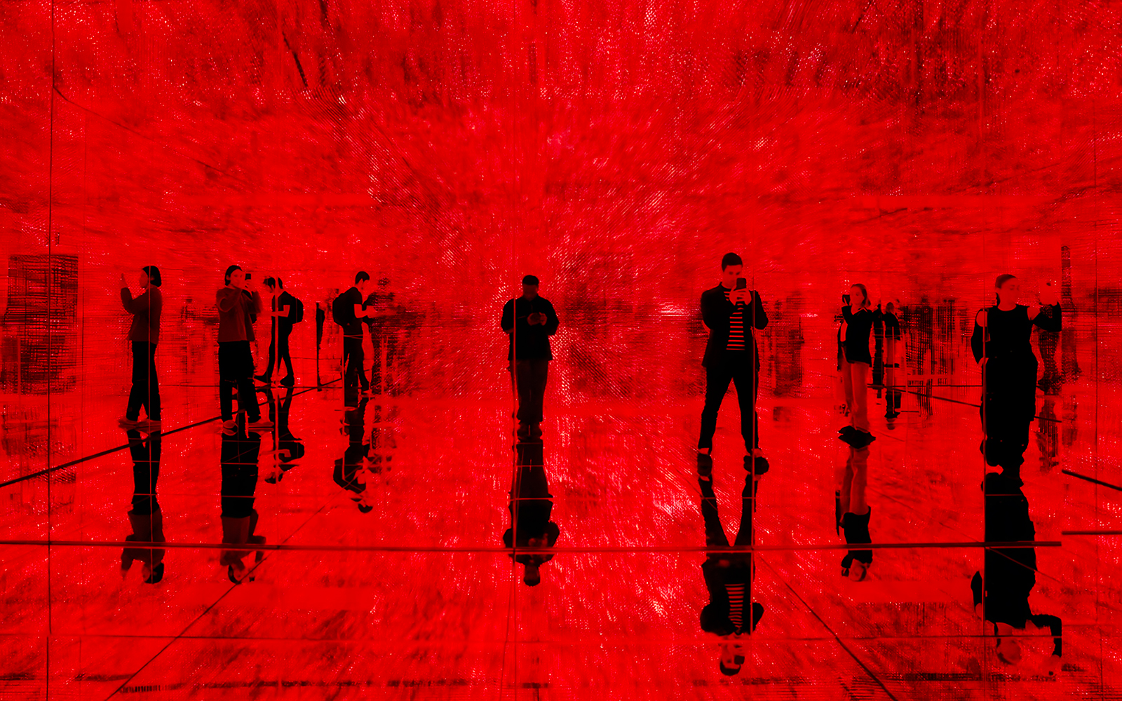 Visitors exploring immersive red light exhibit at Mercer Labs, Museum of Art & Technology.