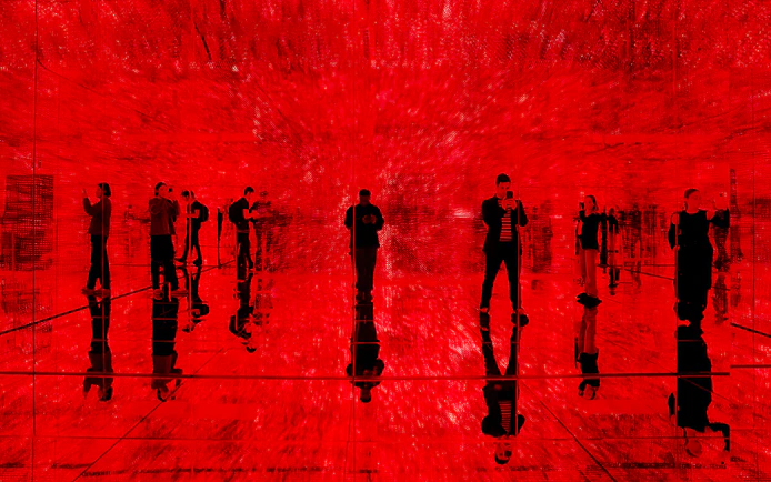 Visitors exploring immersive red light exhibit at Mercer Labs, Museum of Art & Technology.