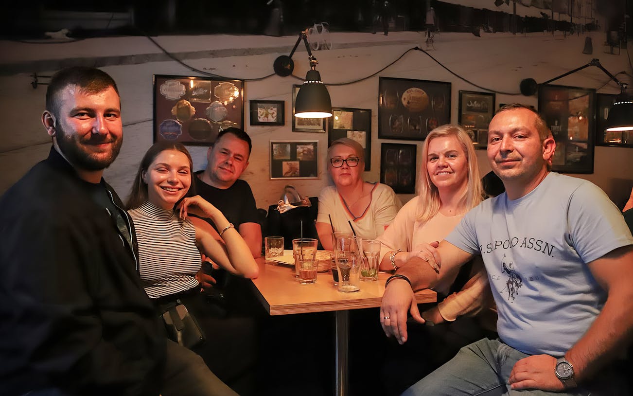 Group enjoying craft beer at a Kraków pub during a walking tour.