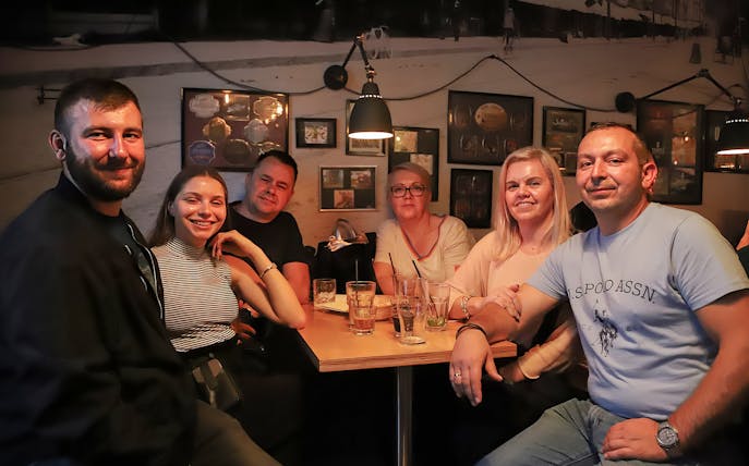 Group enjoying craft beer at a Kraków pub during a walking tour.