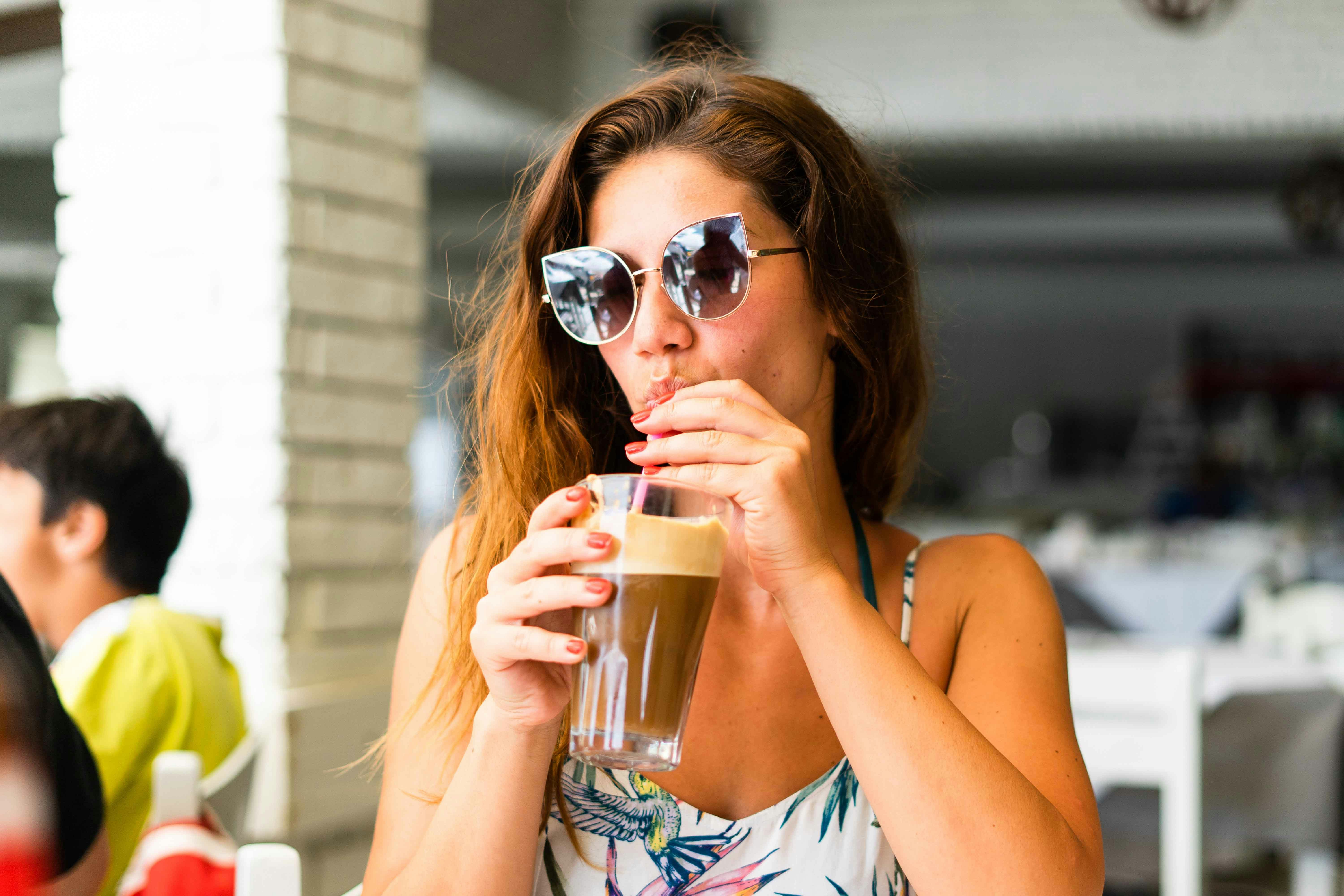 Woman enjoying Greek coffee in an Athens café.