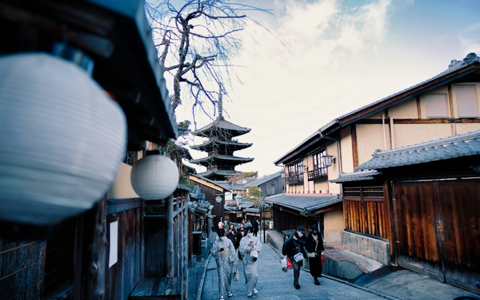 Street view of Kyoto's Gion District with Yasaka Pagoda in the background.