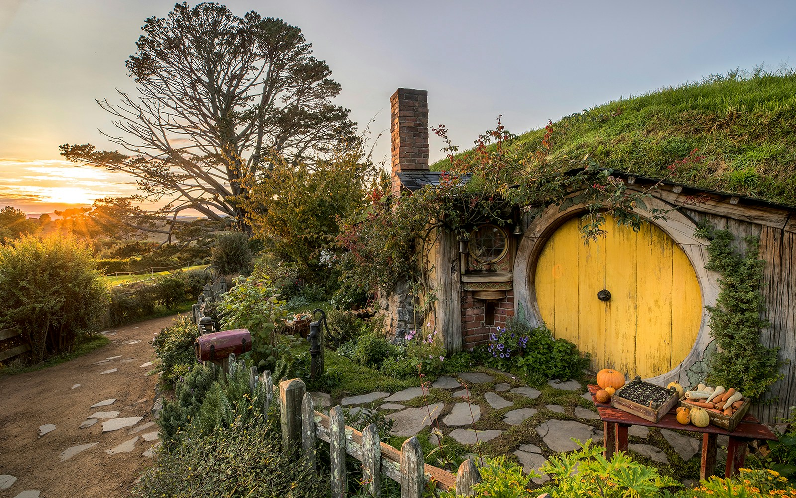 Hobbiton Movie Set with yellow round door and garden in Matamata, New Zealand.