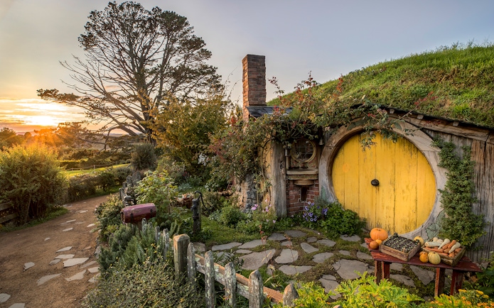 Hobbiton Movie Set with yellow round door and garden in Matamata, New Zealand.