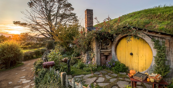 Hobbiton Movie Set with yellow round door and garden in Matamata, New Zealand.
