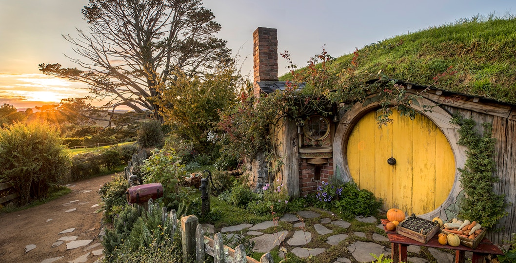 Hobbiton Movie Set with yellow round door and garden in Matamata, New Zealand.