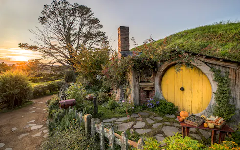 Hobbiton Movie Set with yellow round door and garden in Matamata, New Zealand.