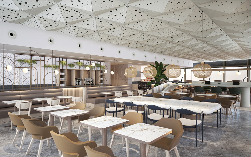 Lounge seating area at Istanbul Ataturk Airport with modern decor and dining tables.