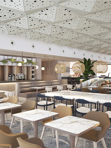 Lounge seating area at Istanbul Ataturk Airport with modern decor and dining tables.