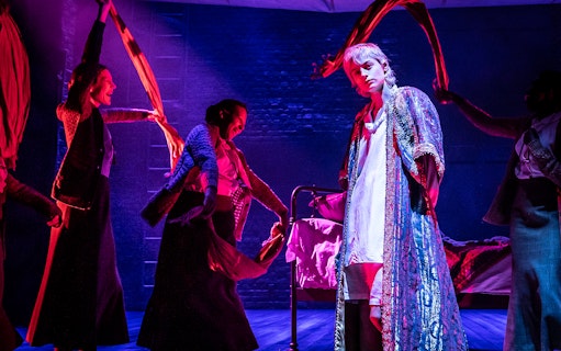 Theatrical performance with actors in vibrant costumes on stage in Orlando.