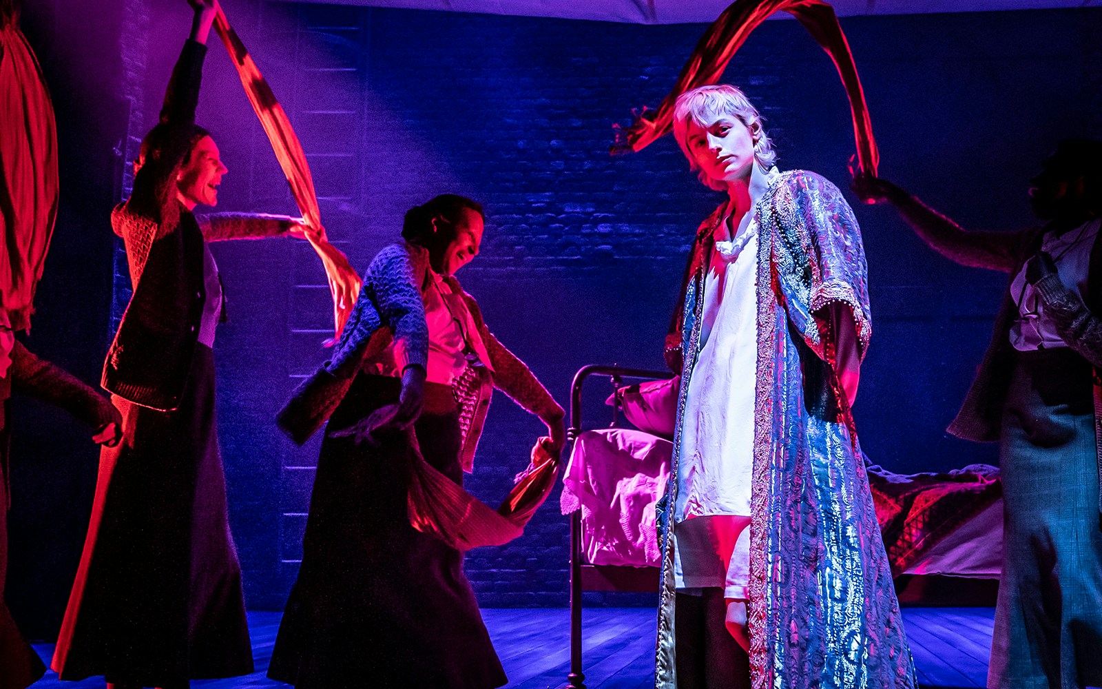 Theatrical performance with actors in vibrant costumes on stage in Orlando.