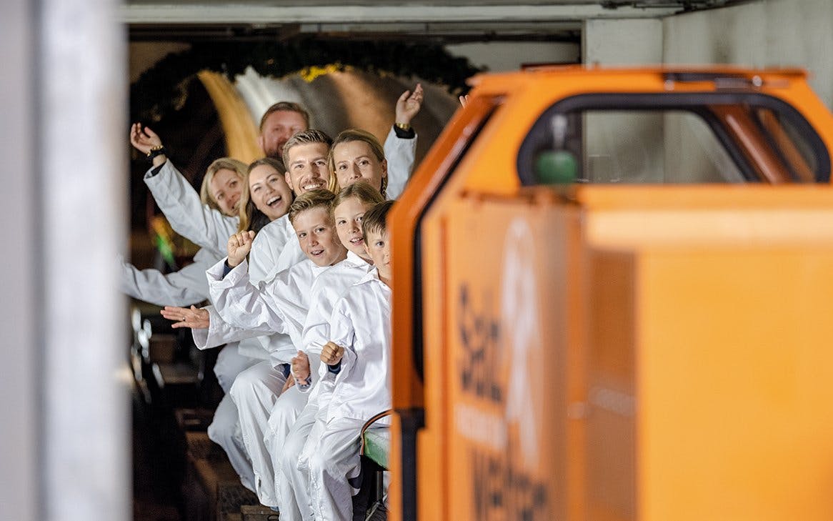 Visitors on a train tour inside Hallein salt mines, Salzburg.