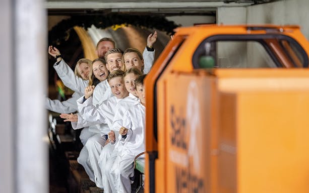Visitors on a train tour inside Hallein salt mines, Salzburg.
