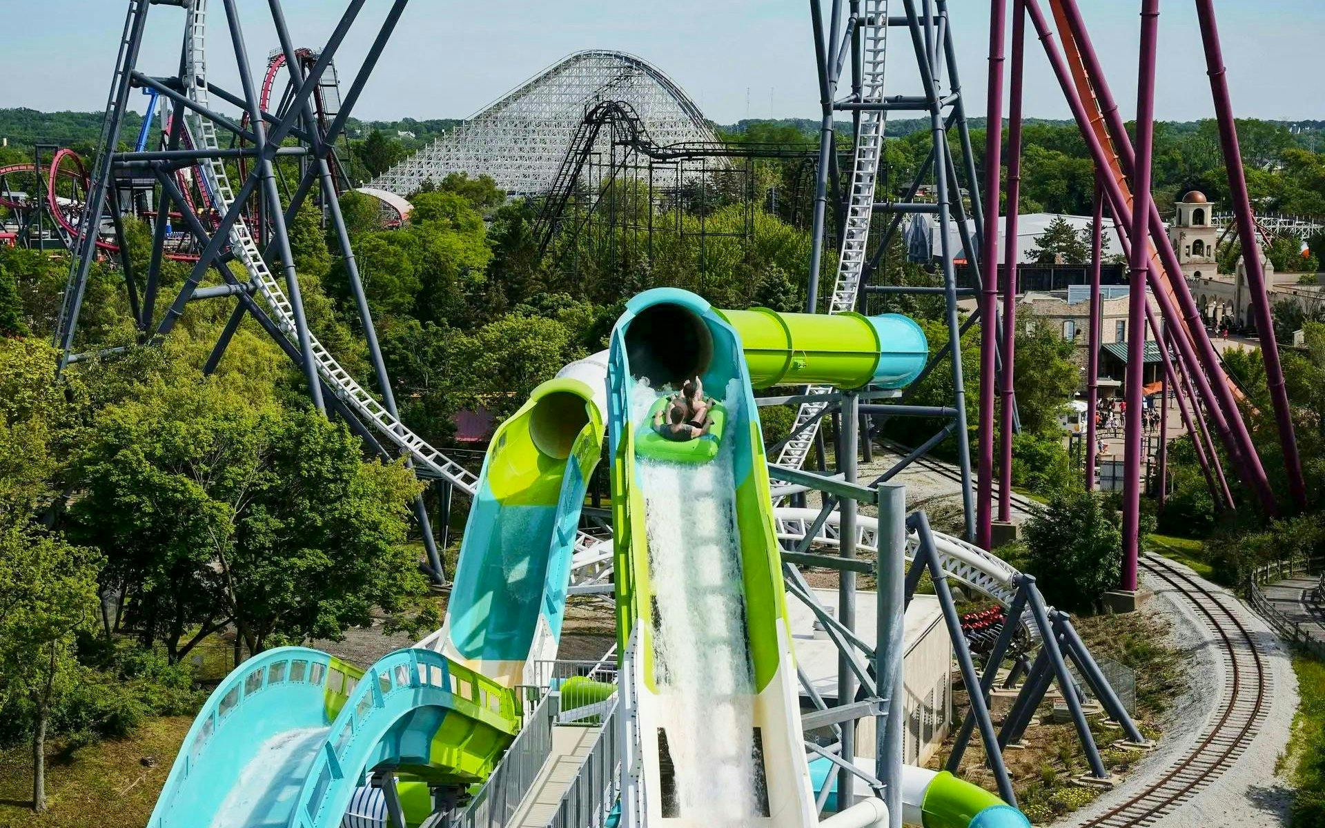 Water slide at Hurricane Harbor Chicago with roller coasters in the background.
