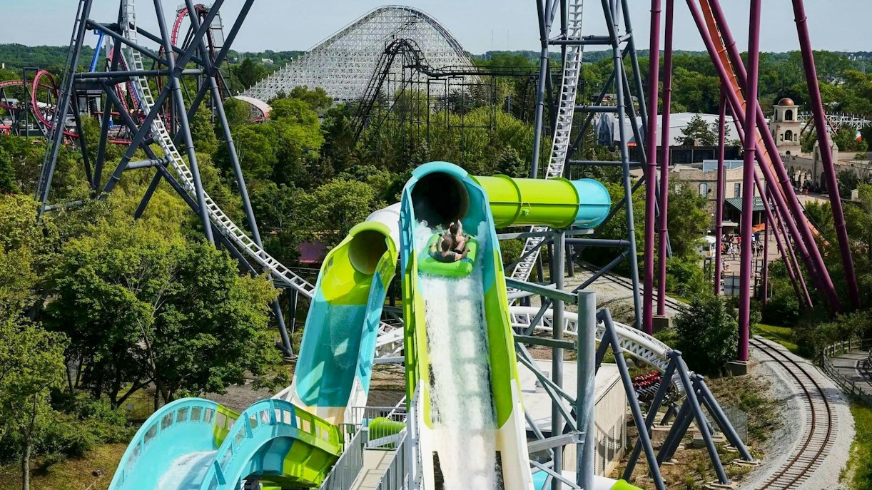 Water slide at Hurricane Harbor Chicago with roller coasters in the background.
