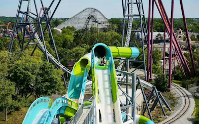 Water slide at Hurricane Harbor Chicago with roller coasters in the background.
