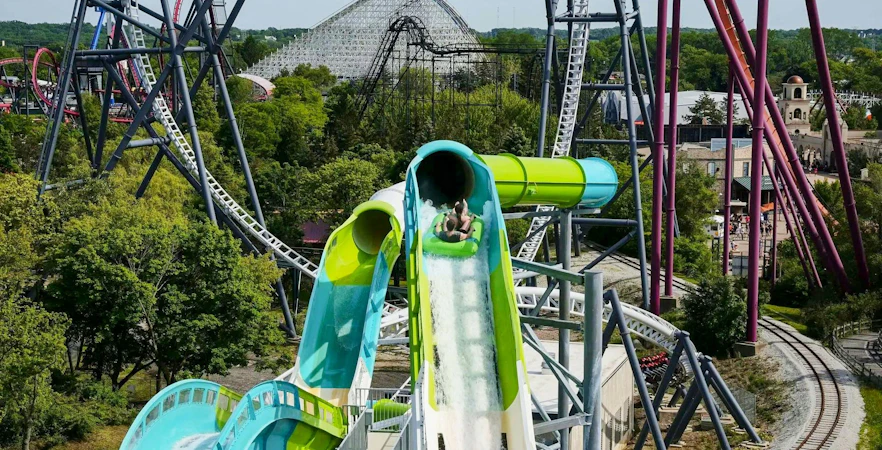 Water slide at Hurricane Harbor Chicago with roller coasters in the background.