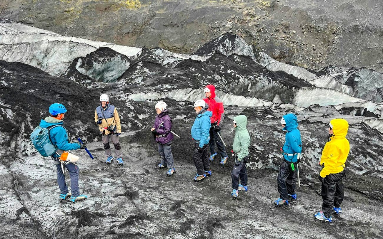 Guests hiking on Sólheimajökull Glacier in Iceland with a guide.