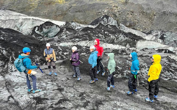 Guests hiking on Sólheimajökull Glacier in Iceland with a guide.