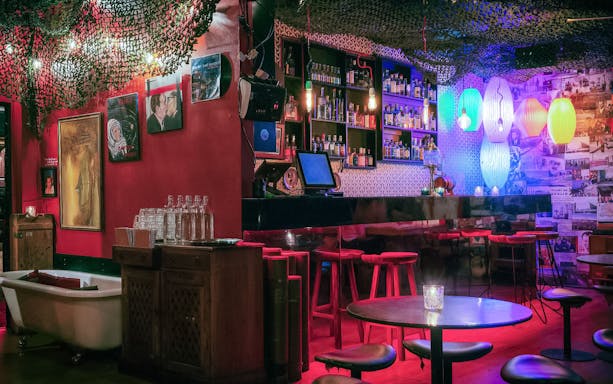 Melbourne bar interior with colorful lights and eclectic decor for hidden cocktail tour.