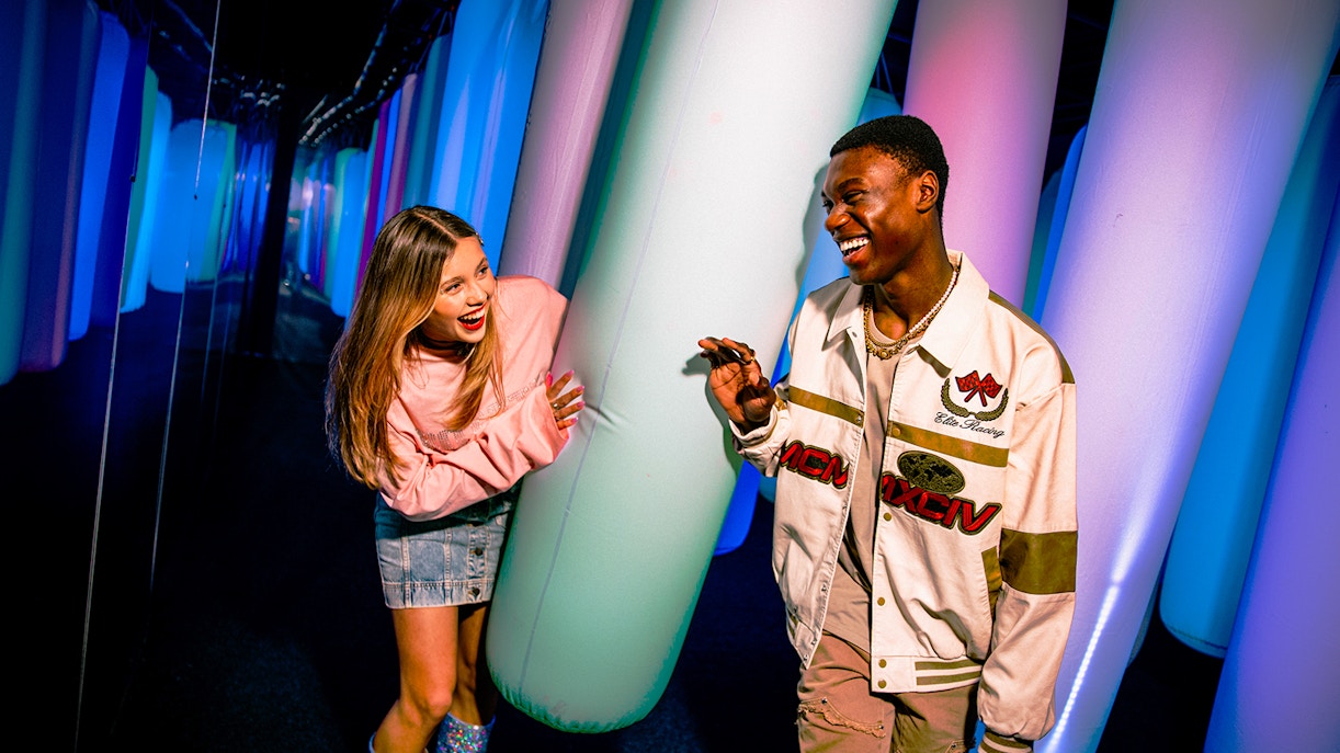 Visitors enjoying colorful inflatable pillars at WONDR Experience.