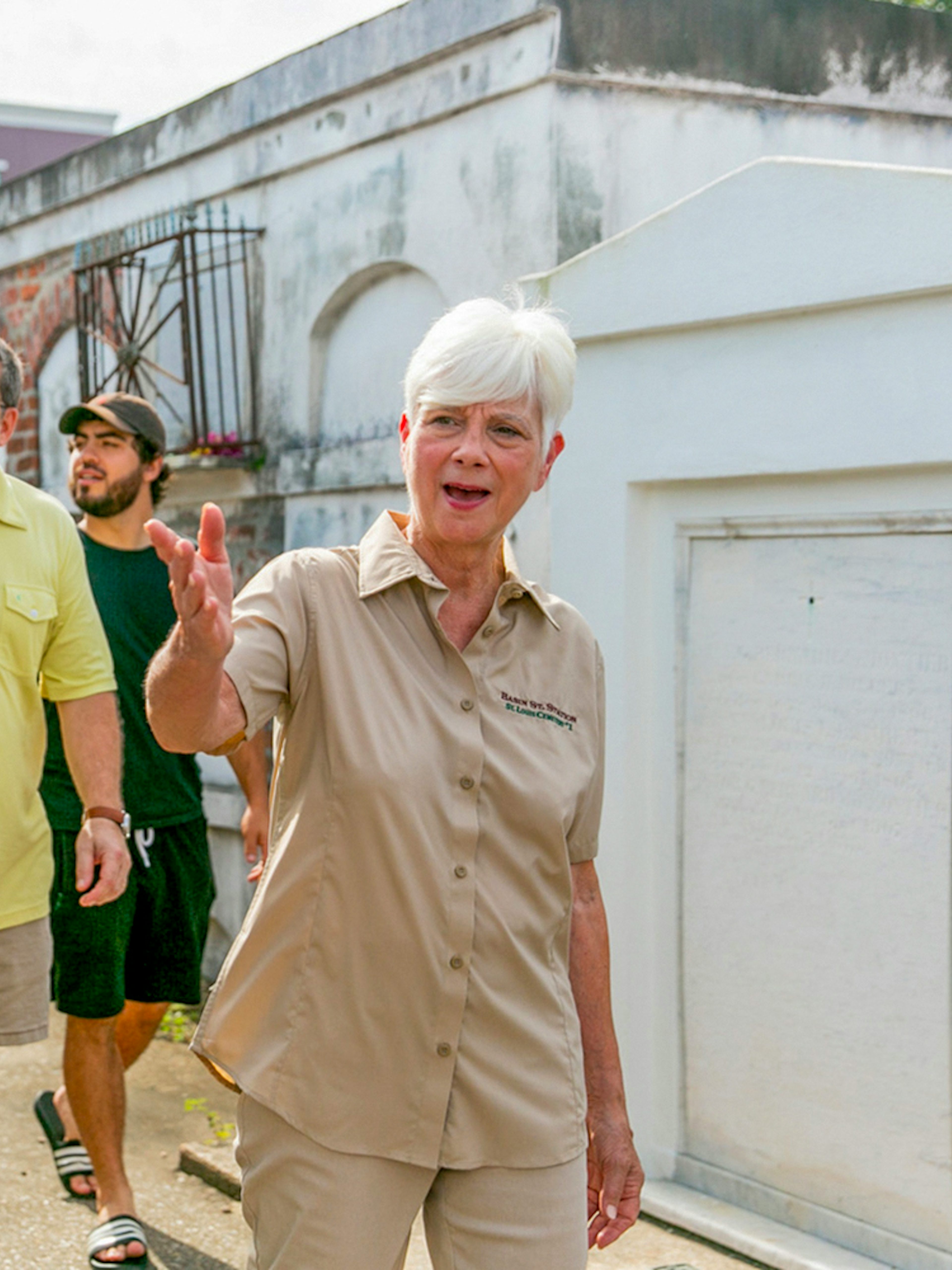 Tour guide leading guests through St. Louis Cemetery in New Orleans.