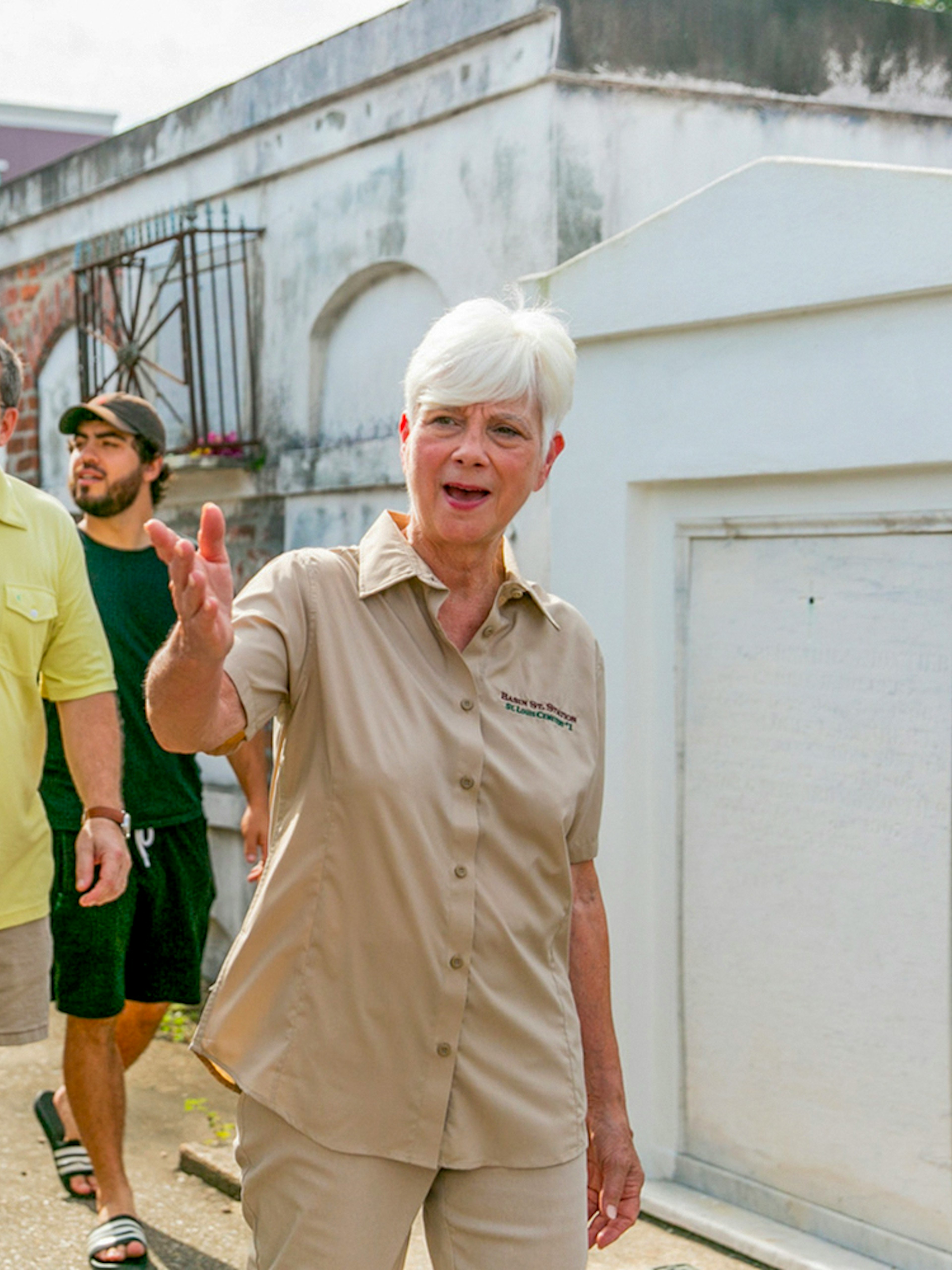 Tour guide leading guests through St. Louis Cemetery in New Orleans.