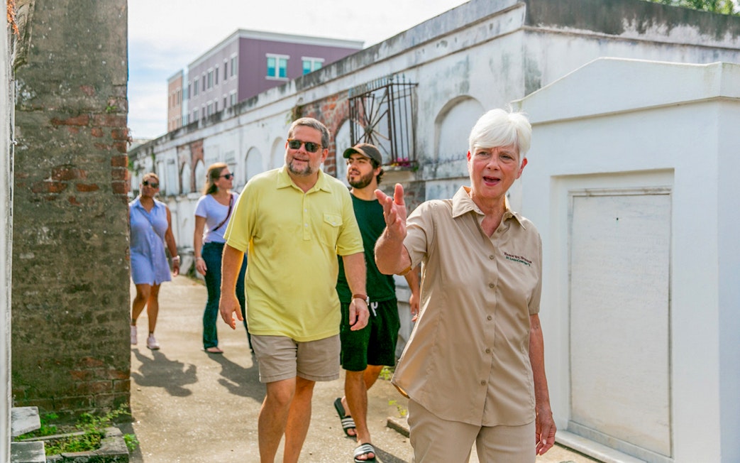 Tour guide leading guests through St. Louis Cemetery in New Orleans.