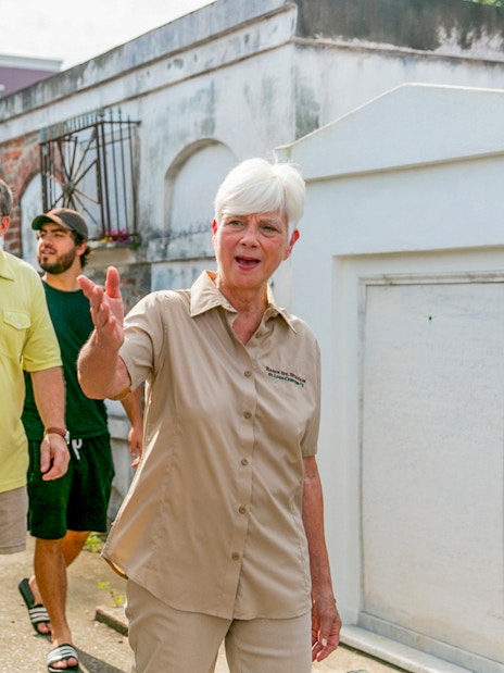 Tour guide leading guests through St. Louis Cemetery in New Orleans.