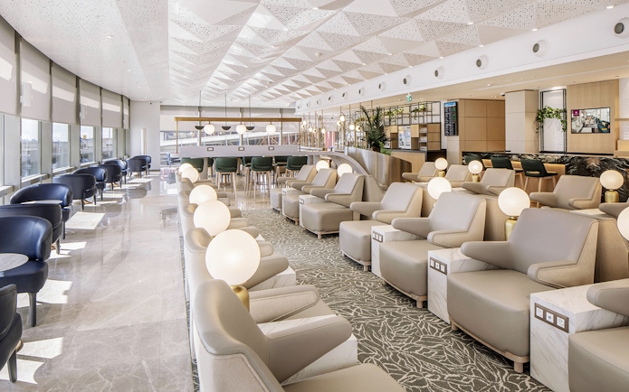 Istanbul Ataturk Airport lounge with seating and modern decor.