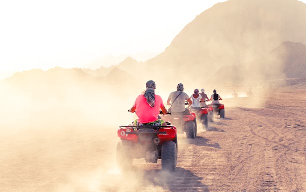 ATVs driving through desert landscape in Hurghada during a safari tour.