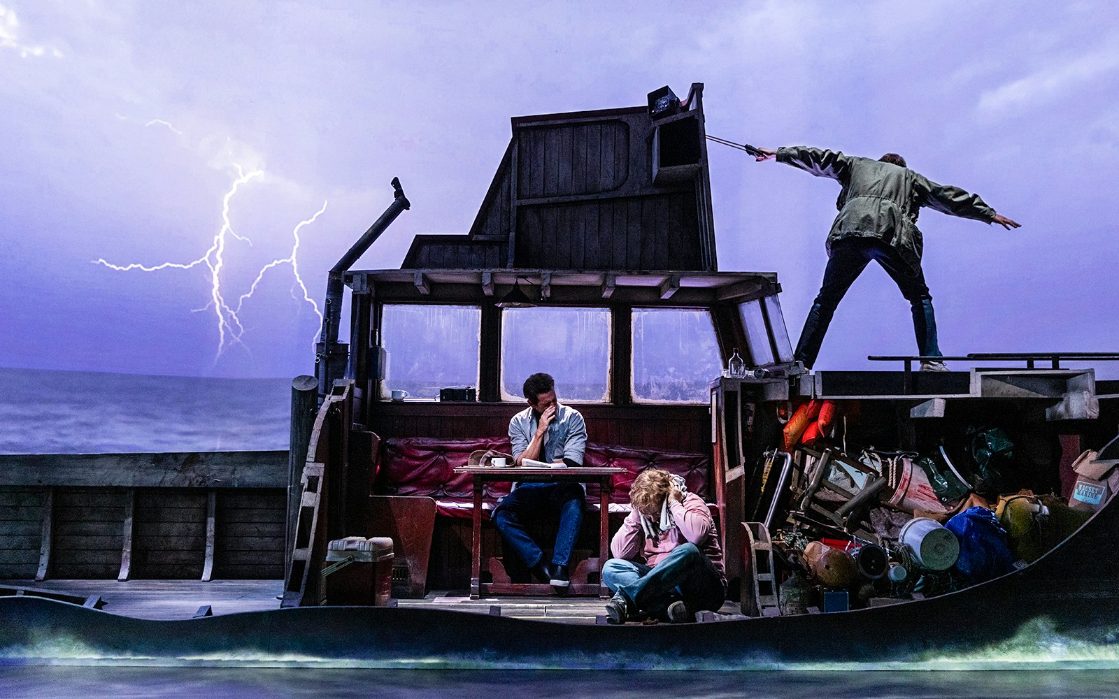 Stage scene from "The Shark is Broken" with actors on a boat during a storm.