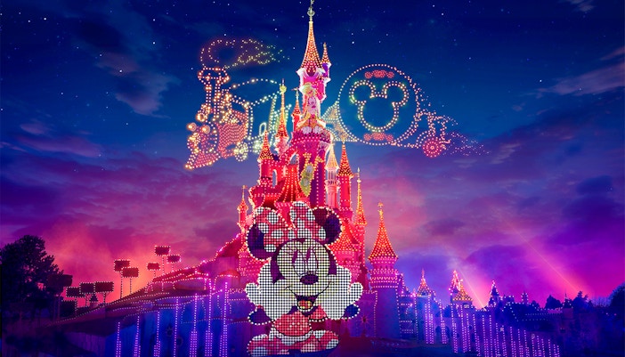 Disneyland Paris Electrical Sky Parade with vibrant floats and fireworks.