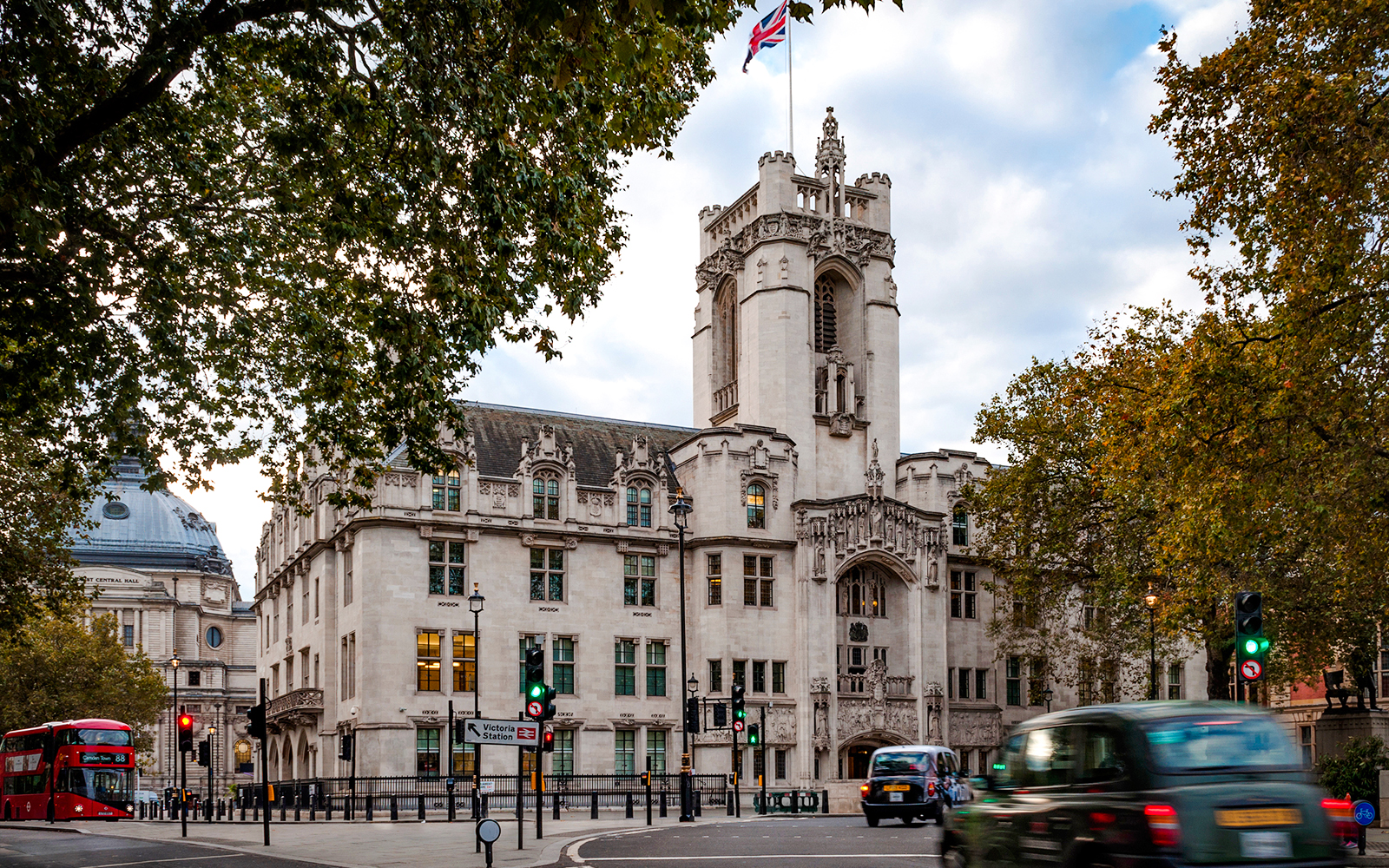 Supreme Court of the United Kingdom building with Union Jack flag, London street view.