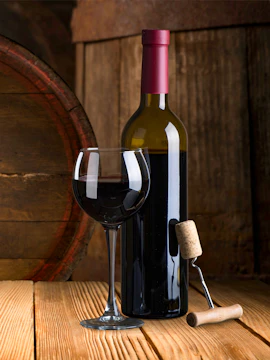 Wine bottle and glass with corkscrew at Real Companhia Velha winery.