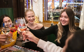 Group toasting with wine glasses during Budapest food tour.